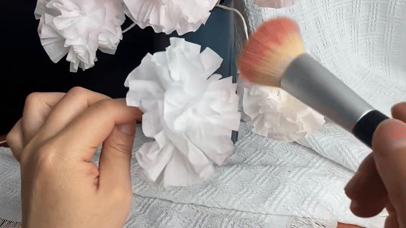 Lightly brush the edges of the petals